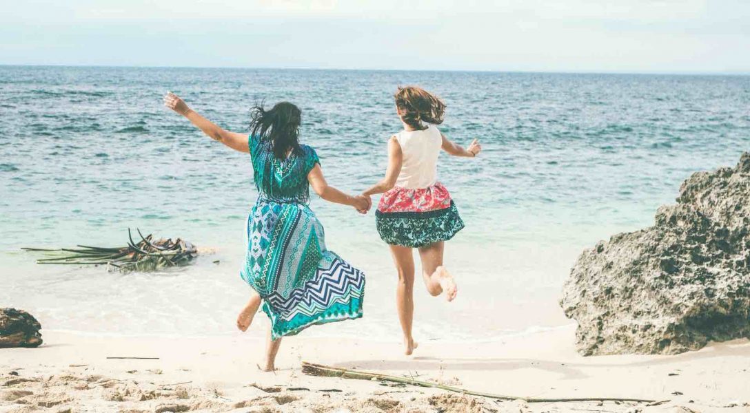 two-women-running-at-the-beach